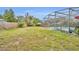 Expansive backyard featuring a green lawn and partial view of the screened-in pool area at 2510 Kiowa Trl, Fern Park, FL 32730