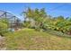 Lush backyard with a vibrant garden and a screened-in pool, ideal for outdoor enjoyment at 2510 Kiowa Trl, Fern Park, FL 32730