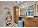 Vanity area featuring cabinetry, dark counters, and decorative shelves at 2510 Kiowa Trl, Fern Park, FL 32730