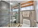 Bathroom featuring a glass shower with river rock base and neutral tile at 2510 Kiowa Trl, Fern Park, FL 32730