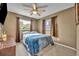Neutral bedroom featuring a ceiling fan and natural light from two windows at 2510 Kiowa Trl, Fern Park, FL 32730