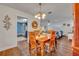 Dining room with wood table, chairs, chandelier, and access to the living room and kitchen at 2510 Kiowa Trl, Fern Park, FL 32730