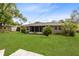 Well-maintained backyard with a screened-in patio and lush green grass at 2618 Grassmere Ln, Orlando, FL 32808