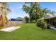Spacious, fenced backyard featuring well-maintained lawn and partial view of screened-in patio at 2618 Grassmere Ln, Orlando, FL 32808