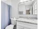 Clean bathroom featuring a new toilet, vanity, and shower with a blue curtain at 2618 Grassmere Ln, Orlando, FL 32808