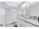 Bright bathroom featuring double sinks, granite countertops, and a shower over tub combo at 2618 Grassmere Ln, Orlando, FL 32808
