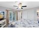 Bedroom with sliding glass doors to screened patio, ceiling fan, and double closet at 2618 Grassmere Ln, Orlando, FL 32808