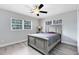Simple bedroom with a bed, neutral colored paint, and two windows at 2618 Grassmere Ln, Orlando, FL 32808