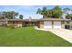 Charming single-story home with a well-maintained lawn and a two-car garage at 2618 Grassmere Ln, Orlando, FL 32808