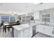 Open-concept kitchen and dining area with granite countertops and white cabinetry at 2618 Grassmere Ln, Orlando, FL 32808