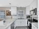 Modern kitchen featuring white cabinets, granite countertops, and stainless steel appliances at 2618 Grassmere Ln, Orlando, FL 32808