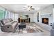 Cozy living room with a brick fireplace, modern furniture, and plenty of natural light at 2618 Grassmere Ln, Orlando, FL 32808