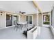 Covered patio featuring a ceiling fan, outdoor dining set, and view of the yard at 2618 Grassmere Ln, Orlando, FL 32808