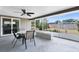Screened-in patio with ceiling fan, outdoor dining set, and view of the backyard at 2618 Grassmere Ln, Orlando, FL 32808