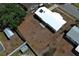 Aerial view of a white roof single-story home with a mostly brown, overgrown yard at 3212 Acoma Dr, Orlando, FL 32829