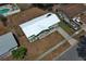 A high aerial view of the light green house, newly redone roof, and long driveway at 3212 Acoma Dr, Orlando, FL 32829