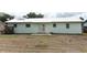 Home exterior with a spacious backyard and double patio doors at 3212 Acoma Dr, Orlando, FL 32829