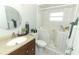 Bright bathroom showcasing accessible tub, granite vanity, and a decorative mirror at 3212 Acoma Dr, Orlando, FL 32829