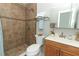 Updated bathroom with tiled walk-in shower and granite vanity at 3212 Acoma Dr, Orlando, FL 32829