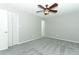 Bedroom with new gray carpet, closet, and ceiling fan at 3212 Acoma Dr, Orlando, FL 32829