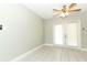 Bedroom features tile flooring, neutral paint, modern fan, and french doors at 3212 Acoma Dr, Orlando, FL 32829