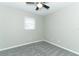 Comfortable bedroom featuring neutral walls, gray carpet, ceiling fan, and bright windows at 3212 Acoma Dr, Orlando, FL 32829
