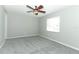 Spacious bedroom featuring new gray carpet and a ceiling fan at 3212 Acoma Dr, Orlando, FL 32829
