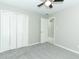 Neutral bedroom featuring a ceiling fan, carpeting, closet, and bright natural light at 3212 Acoma Dr, Orlando, FL 32829