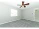 Bedroom with new gray carpet and a ceiling fan at 3212 Acoma Dr, Orlando, FL 32829