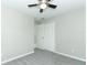 Cozy bedroom features plush gray carpeting, neutral walls, and ceiling fan at 3212 Acoma Dr, Orlando, FL 32829
