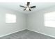 Comfortable bedroom featuring neutral walls, gray carpet, ceiling fan, and bright windows at 3212 Acoma Dr, Orlando, FL 32829