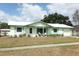 Charming single-story home boasts fresh paint, updated windows, and inviting front porch seating at 3212 Acoma Dr, Orlando, FL 32829