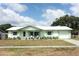 Charming single-story home boasts fresh paint, updated windows, and inviting front porch seating at 3212 Acoma Dr, Orlando, FL 32829