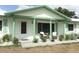 Inviting covered front porch with seating and meticulously landscaped yard at 3212 Acoma Dr, Orlando, FL 32829