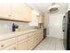 Charming kitchen featuring cream-colored cabinets and modern black appliances at 3212 Acoma Dr, Orlando, FL 32829
