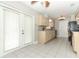 Bright kitchen with ample counter space, white cabinets, and access to the outdoor patio at 3212 Acoma Dr, Orlando, FL 32829