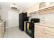 Bright kitchen with a black refrigerator and black oven at 3212 Acoma Dr, Orlando, FL 32829