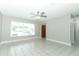 Bright living room features tile floors, neutral paint, and a modern ceiling fan at 3212 Acoma Dr, Orlando, FL 32829