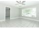 Bright living room features tile floors, neutral paint, and a modern ceiling fan at 3212 Acoma Dr, Orlando, FL 32829