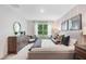 A bright bedroom with large window offers natural light and features a stylish, comfortable design at 3821 Royal Azalea Way, Sanford, FL 32773
