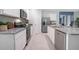 Well-lit kitchen showcasing stainless steel appliances, white cabinets, and sleek granite countertops at 3833 Royal Azalea Way, Sanford, FL 32773
