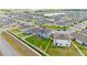 An aerial view showcasing a home with solar panels, a green backyard with playset, and a fenced property at 4054 Silverstream Ter, Sanford, FL 32771