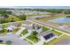 An aerial view of a residential area showcasing homes with well-kept lawns, ponds, and tree-lined streets at 4054 Silverstream Ter, Sanford, FL 32771