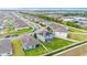 Aerial view of a neighborhood, houses with solar panels, green lawns, outdoor furniture, and a play set at 4054 Silverstream Ter, Sanford, FL 32771