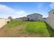 Expansive backyard with lush green grass, perimeter fencing, and a distant view of neighboring houses at 4054 Silverstream Ter, Sanford, FL 32771