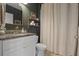 Cozy bathroom featuring a marble vanity, updated fixtures, and walk-in shower with floor to ceiling tiling at 4054 Silverstream Ter, Sanford, FL 32771