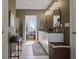 Elegant bathroom with double sinks, granite counters, tile floors, and a walk-in shower at 4054 Silverstream Ter, Sanford, FL 32771