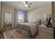 Serene bedroom with a full length mirror, comfortable bed, and soft natural light from the window at 4054 Silverstream Ter, Sanford, FL 32771