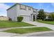 Gray stucco home with two car garage and manicured landscaping in front yard at 4054 Silverstream Ter, Sanford, FL 32771