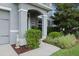 Covered entry of gray stucco home with nicely landscaped front yard at 4054 Silverstream Ter, Sanford, FL 32771